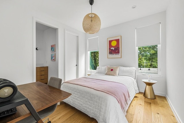 bedroom featuring baseboards and light wood-style floors