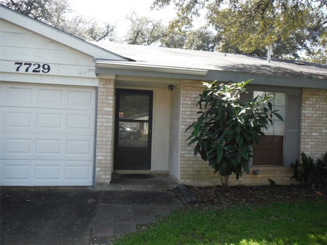 7729 Croftwood Dr, Austin, TX 78749 - view of exterior entry with brick siding and an attached garage