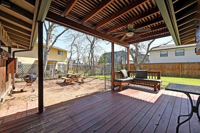 wooden terrace featuring a fenced backyard and a ceiling fan