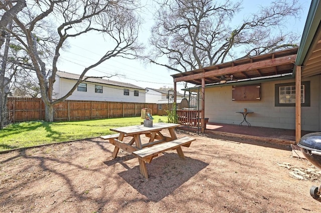 view of yard with a patio, outdoor dining area, and a fenced backyard