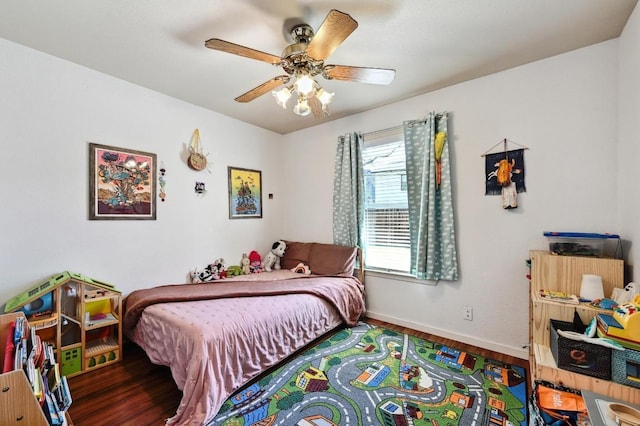 bedroom featuring wood finished floors, baseboards, and ceiling fan