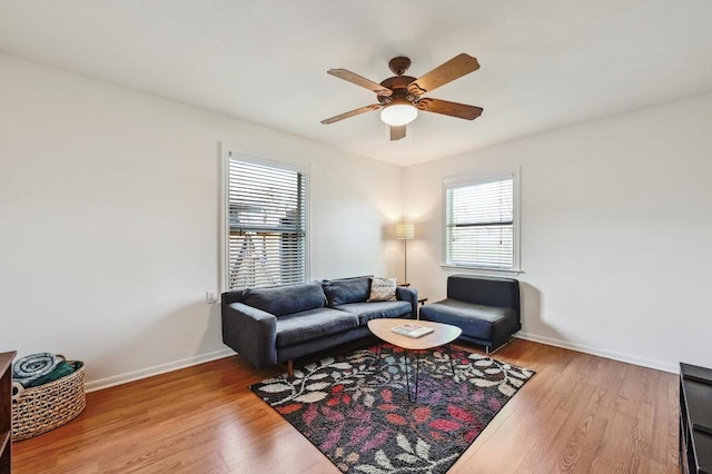 living room with wood finished floors, plenty of natural light, and a ceiling fan