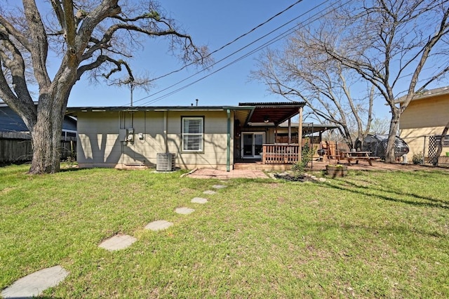 rear view of property featuring a yard, a patio, cooling unit, and fence