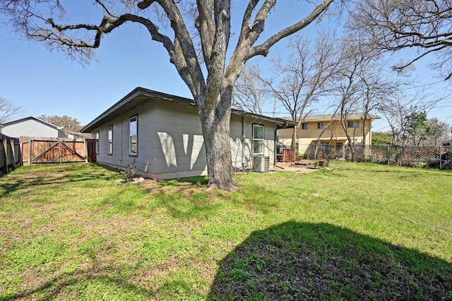 view of yard featuring a gate and a fenced backyard