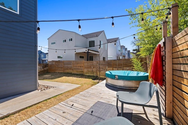 wooden deck featuring a fenced backyard and a residential view