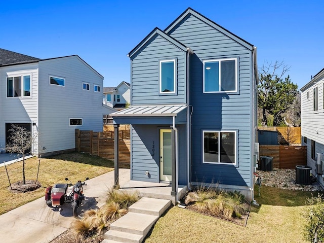 view of front of home with a patio area, central air condition unit, a front lawn, and fence