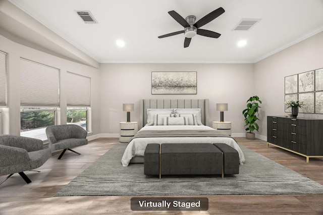 bedroom featuring crown molding, wood finished floors, baseboards, and visible vents