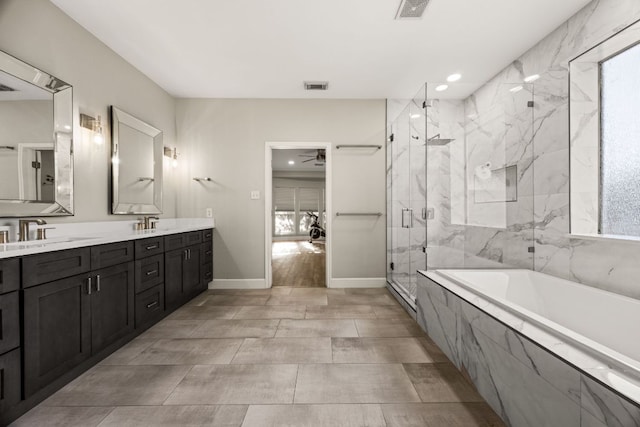 full bath with a sink, visible vents, a bath, and double vanity