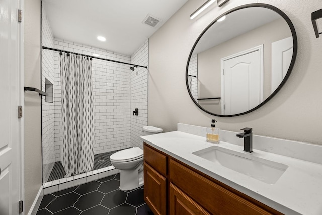 full bath with visible vents, a stall shower, toilet, and vanity