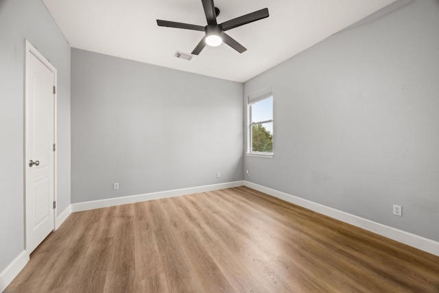 spare room featuring visible vents, baseboards, light wood-type flooring, and a ceiling fan