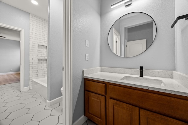 full bath featuring vanity, baseboards,  shower combination, tile patterned floors, and toilet