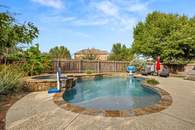 view of pool featuring a pool with connected hot tub, a fenced backyard, and a patio area