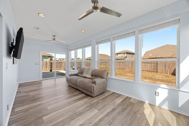 sunroom / solarium featuring visible vents and ceiling fan