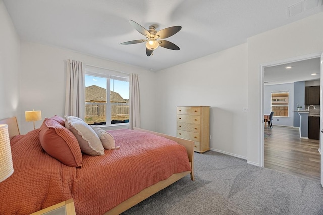 carpeted bedroom with a ceiling fan, baseboards, and visible vents