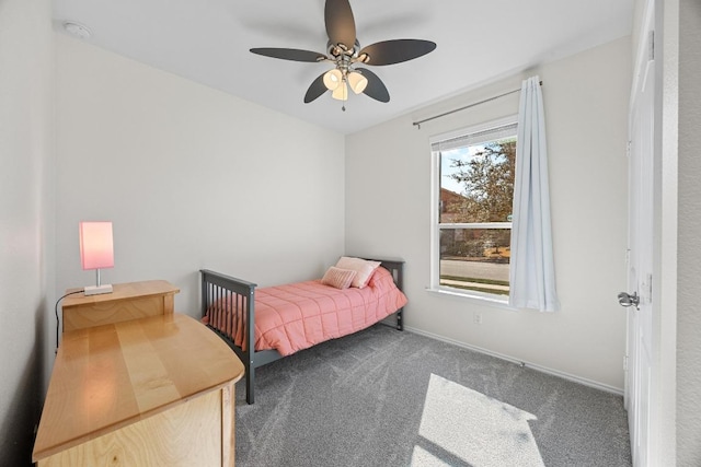 bedroom with carpet flooring, baseboards, and a ceiling fan