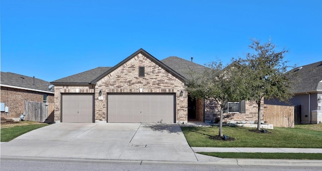 view of front facade featuring a garage, a front lawn, brick siding, and driveway