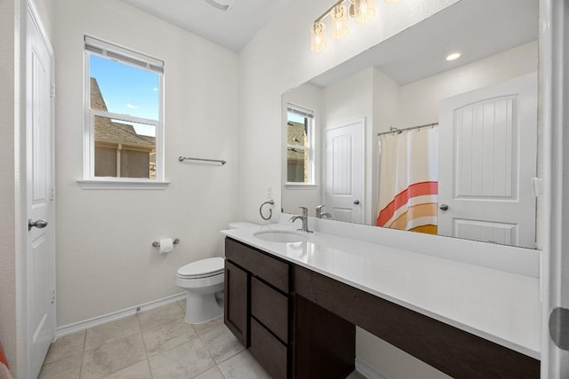 bathroom with tile patterned floors, toilet, vanity, and baseboards