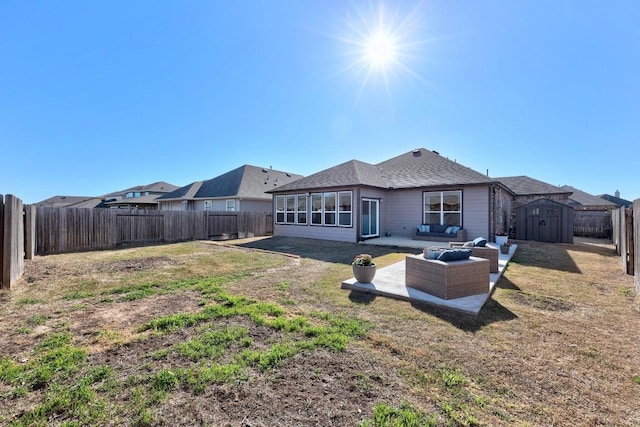 rear view of property featuring outdoor lounge area, a yard, a fenced backyard, an outdoor structure, and a storage unit