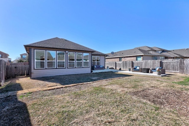 rear view of property with a patio area, a yard, a fenced backyard, and roof with shingles