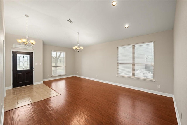 157 Mcgarity, Kyle, TX 78640 - entryway featuring a chandelier, wood finished floors, baseboards, and lofted ceiling