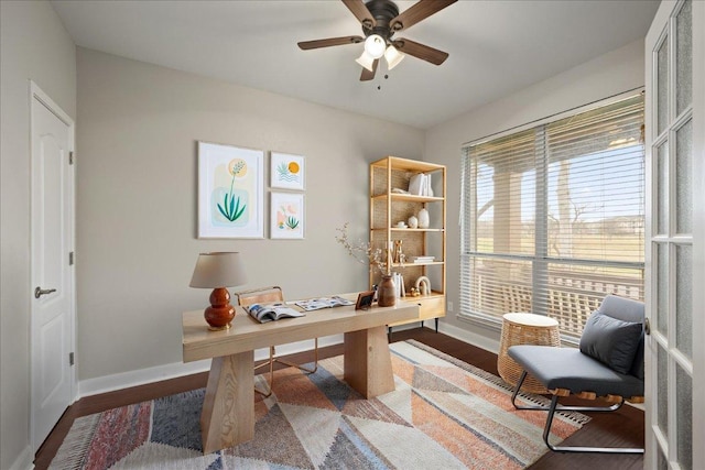 office space featuring baseboards, wood finished floors, and ceiling fan