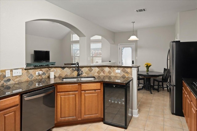 kitchen featuring dishwasher, wine cooler, brown cabinets, and a sink