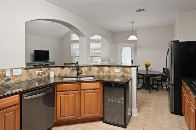 157 Mcgarity, Kyle, TX 78640 - kitchen with dishwasher, a sink, freestanding refrigerator, beverage cooler, and brown cabinetry