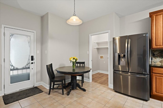 157 Mcgarity, Kyle, TX 78640 - dining room featuring light tile patterned flooring and baseboards