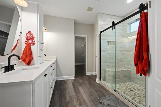 157 Mcgarity, Kyle, TX 78640 - bathroom featuring double vanity, baseboards, wood finished floors, and a stall shower