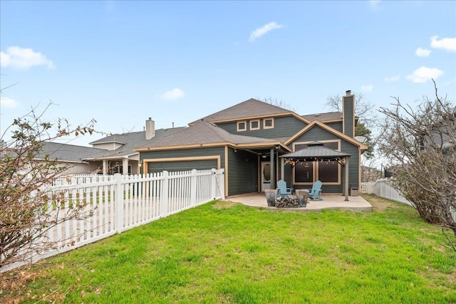 157 Mcgarity, Kyle, TX 78640 - back of property with a chimney, a gazebo, an attached garage, a patio, and a fire pit