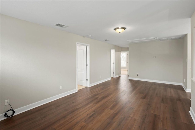157 Mcgarity, Kyle, TX 78640 - spare room with dark wood-type flooring, attic access, and baseboards