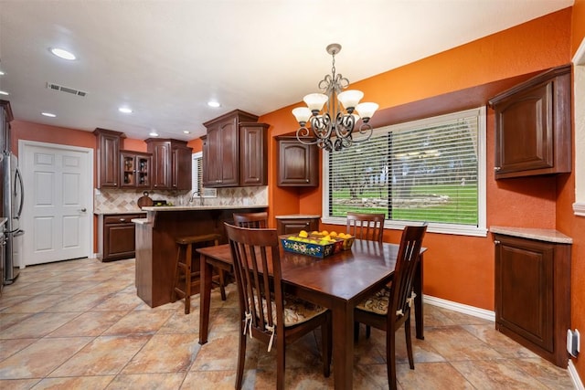 dining area featuring recessed lighting, visible vents, baseboards, and a chandelier