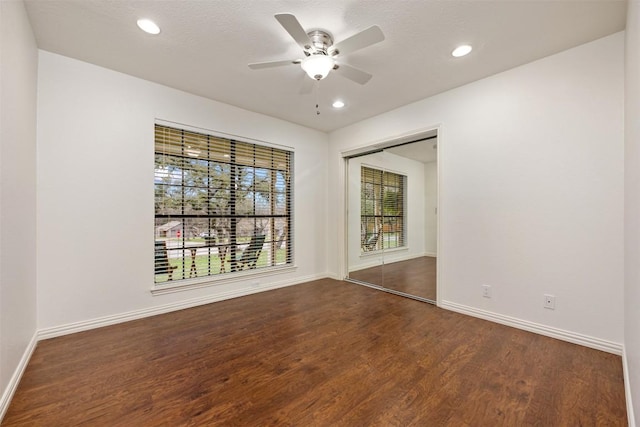 unfurnished room with recessed lighting, ceiling fan, dark wood-type flooring, and baseboards