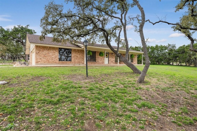 ranch-style house with brick siding and a front lawn