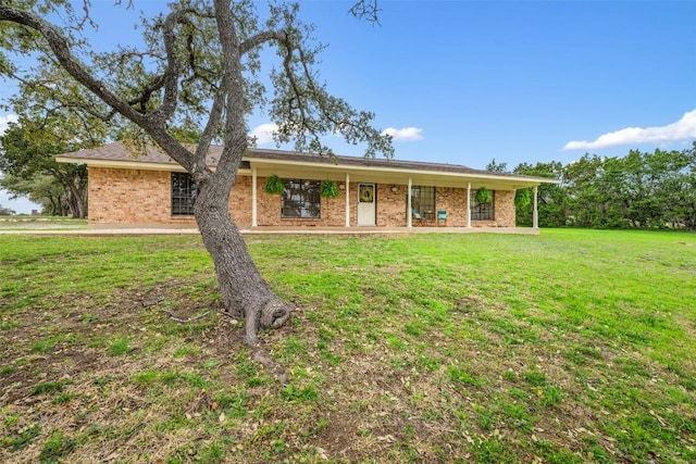 ranch-style house featuring brick siding and a front lawn