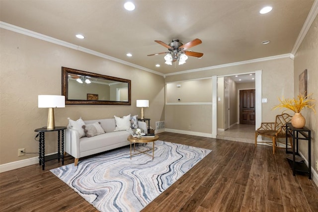 living area featuring baseboards, wood finished floors, ceiling fan, and crown molding