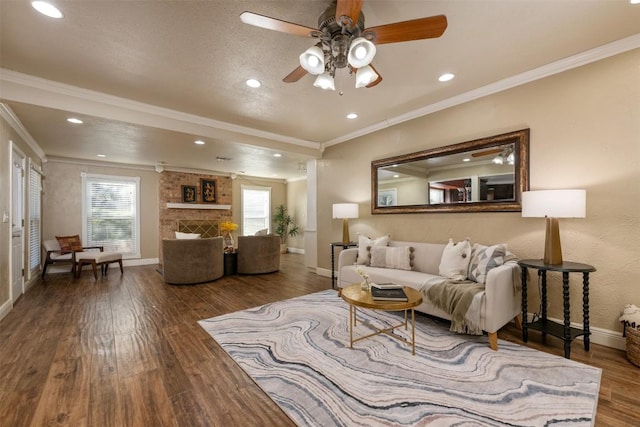 living area featuring ceiling fan, baseboards, wood finished floors, and ornamental molding