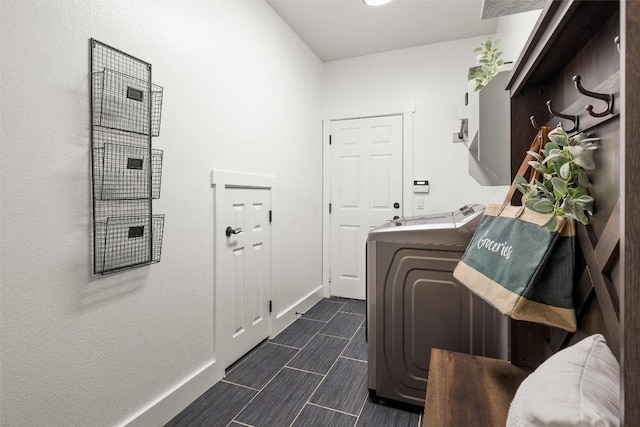 clothes washing area featuring baseboards, independent washer and dryer, and laundry area