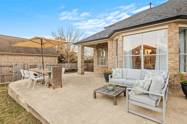 view of patio / terrace featuring outdoor dining space, an outdoor living space, and fence