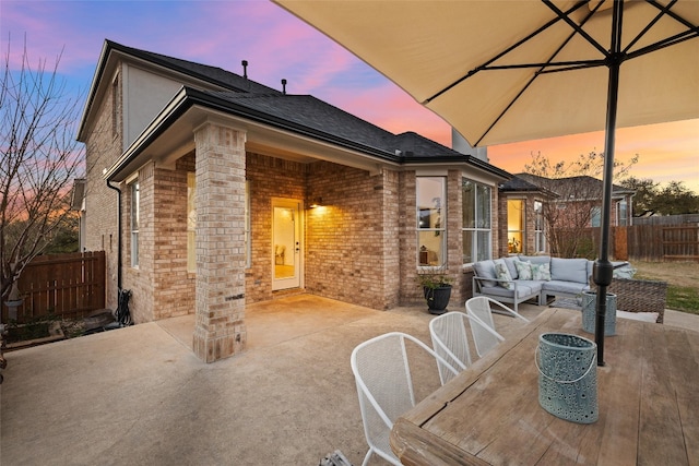 view of patio featuring outdoor lounge area, outdoor dining space, and fence