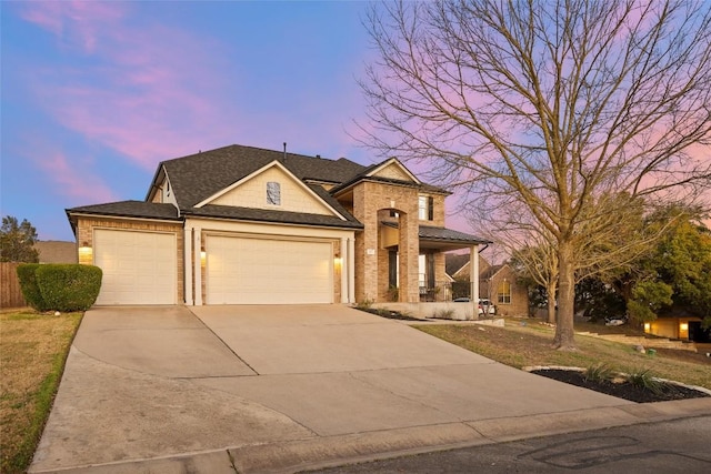 view of front of property with concrete driveway, an attached garage, and covered porch