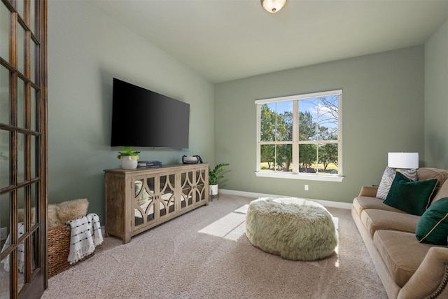 carpeted living room with baseboards