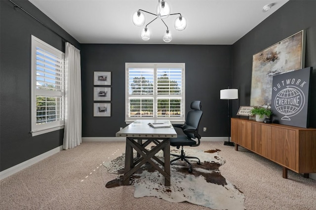 office space with light colored carpet, a chandelier, and baseboards