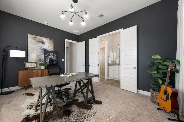 office space featuring light colored carpet, a notable chandelier, baseboards, and visible vents