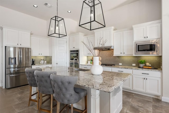 kitchen with stainless steel appliances, white cabinetry, and recessed lighting