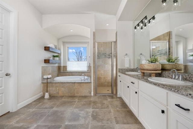 bathroom with a sink, a bath, and a shower stall