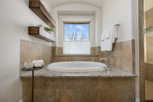 full bathroom with tiled shower and a garden tub