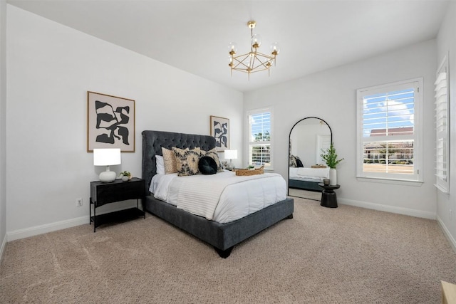 bedroom featuring a chandelier, multiple windows, baseboards, and carpet floors