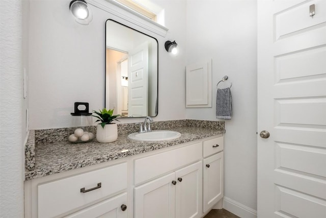 bathroom with baseboards and vanity