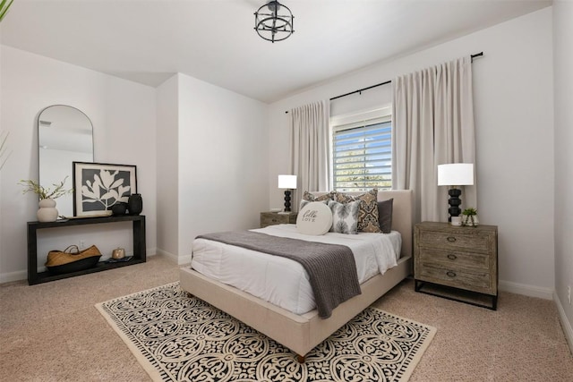 carpeted bedroom featuring baseboards